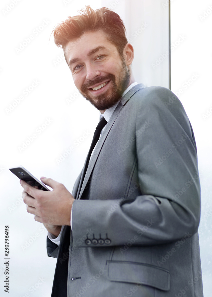 Stylish man in suit is reading information on phone Stylish man in suit is reading information on phone