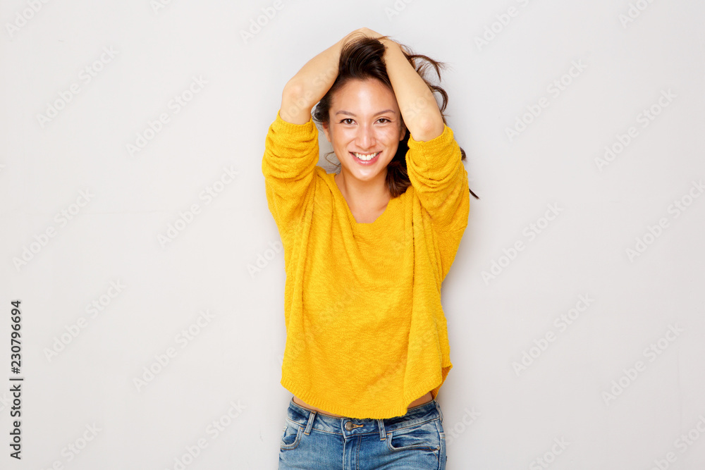 happy asian girl smiling with hands in hair happy asian girl smiling with hands in hair