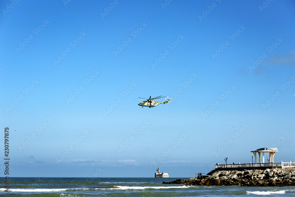 Fototapeta premium a helicopter over the sea and a gazebo with an inscription in Russian 