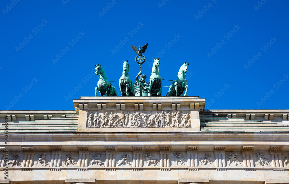 Obraz premium Brandenburg gate, Berlin, Germany, low angle against blue sky.