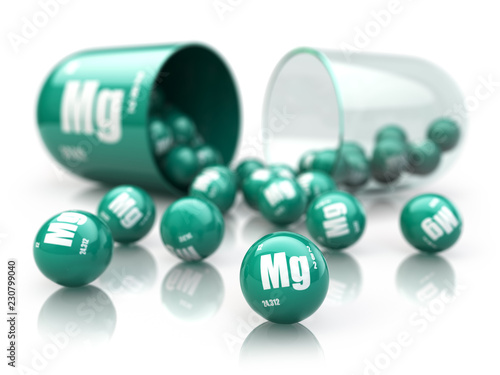 Capsule with magnesium Mg  element.  Dietary supplements. Vitamin capsule isolated on white. photo