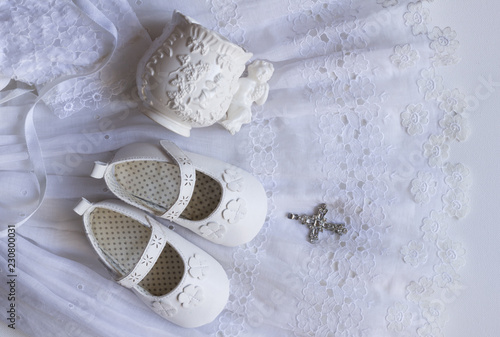 Stampa su tela Christening baby shoes, christening cup and crystal cross pendant on vintage lac
