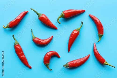 Red Chili Pepper Pattern. Blue background. Top view. Food backdrop. 
