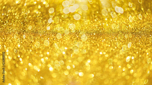 Glitter defocused abstract background with blurry lights, stars. Christmas festive texture. New year party