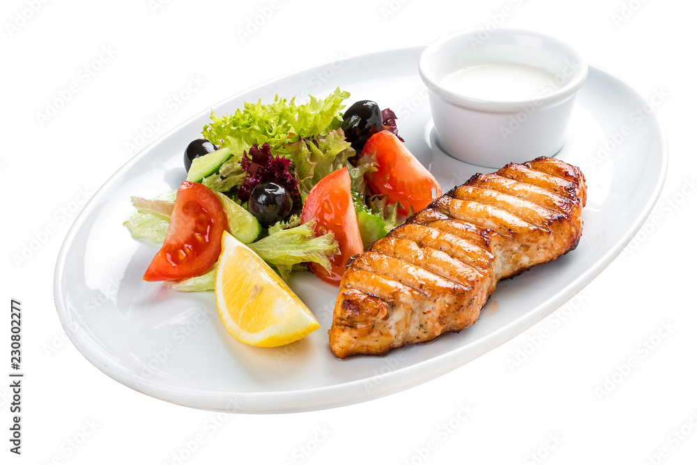 Grilled salmon steak with vegetables. On a white plate Grilled salmon steak with vegetables. On a white plate