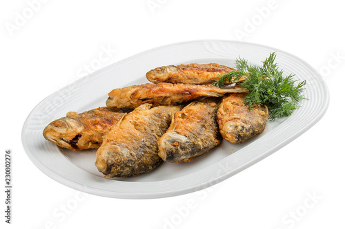 Fried carp on a white plate