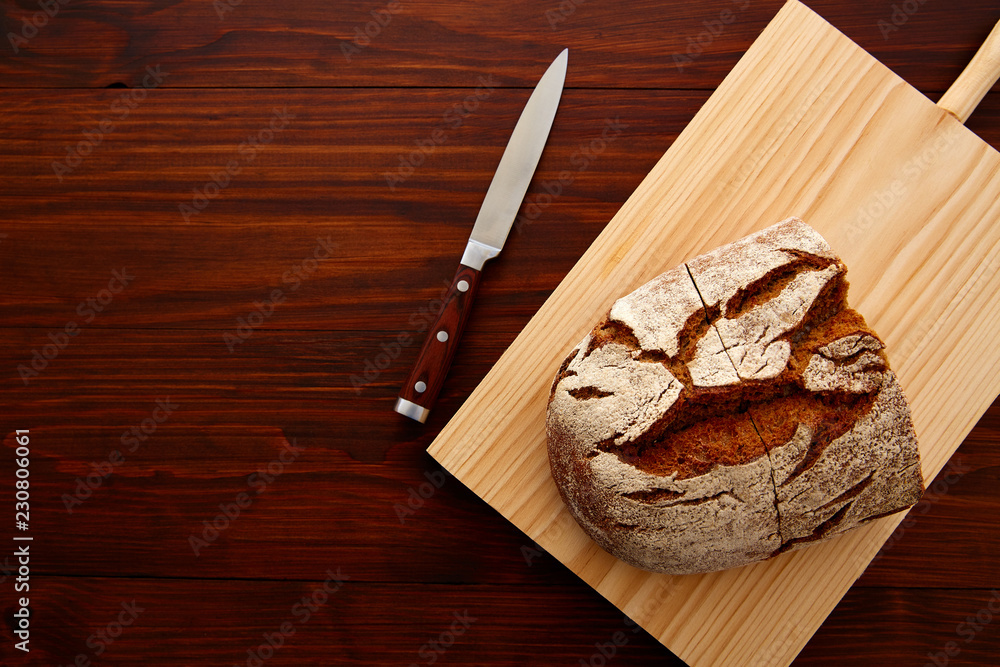 Fototapeta premium Rye bread on dark wooden table