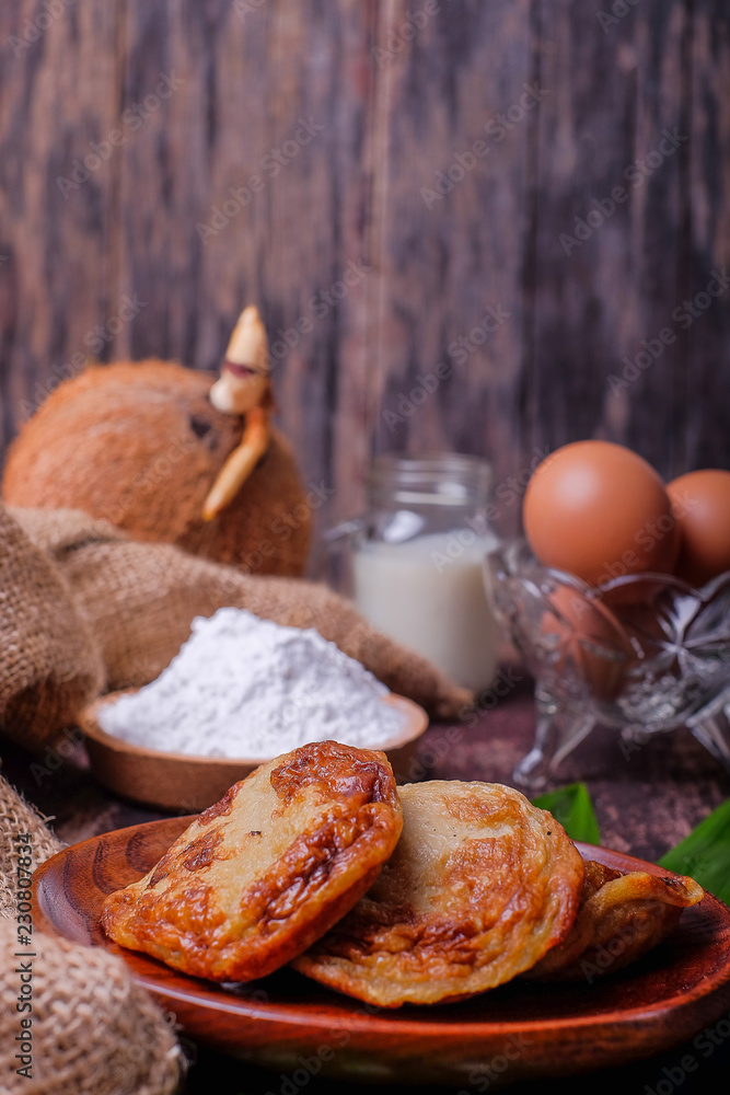 Akok Kedut, egg, coconut, flour , coconut milk and Pandan leaf on wooden background. Akok Kedut is a traditional dish in Malaysia especially East Coast. Akok Kedut, egg, coconut, flour , coconut milk and Pandan leaf on wooden background. Akok Kedut is a traditional dish in Malaysia especially East Coast.