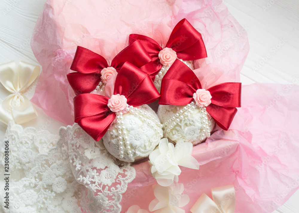winter holiday decoration. Handmade Christmas ball decorated with a satin red ribbon, plastic flowers, pearls, lace. winter holiday decoration. Handmade Christmas ball decorated with a satin red ribbon, plastic flowers, pearls, lace.