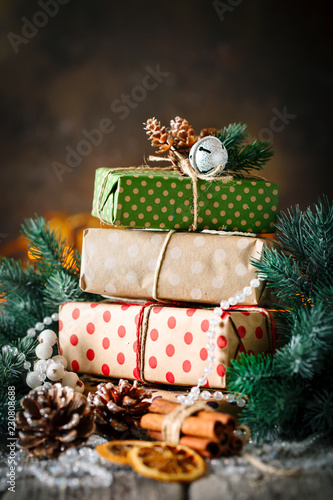 Merry Christmas and happy New year. Christmas gift and Christmas tree on dark wooden background. Selective focus.