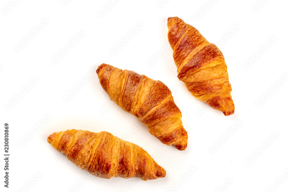 An overhead photo of three croissants, shot from above on a white background with copy space An overhead photo of three croissants, shot from above on a white background with copy space