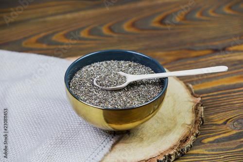 Healthy Chia seeds with wooden spoon on the table close-up