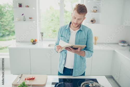 Minded pensive ponder husband look at paper book reader recipe f