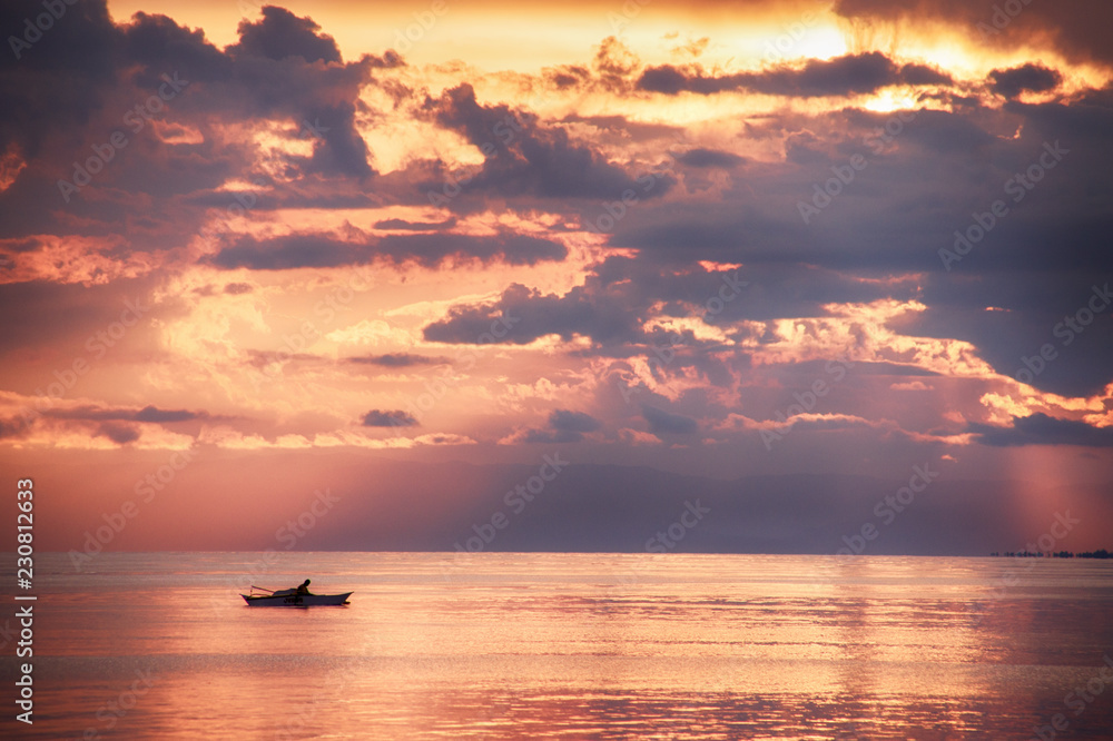 fishing boat at spectacular sunset over the ocean