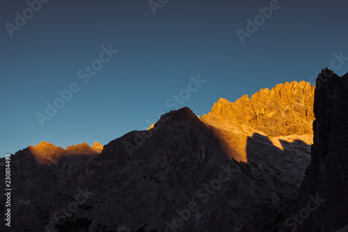 Awesome shadow games on dolomite walls of Cima Undici at sunset, South Tyrol, Italy