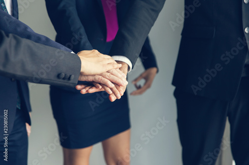 Business men and Asian women holding hands in the Office.