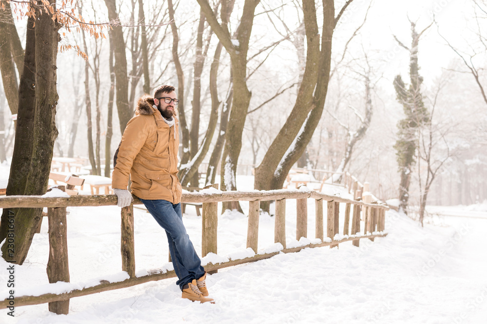 Man enjoying snowy winter day in nature Man enjoying snowy winter day in nature