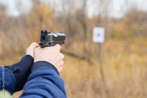 hands with a gun aim at the target