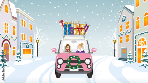 Two women riding the pink Car which loaded a lot of Christmas gifts in the winter town