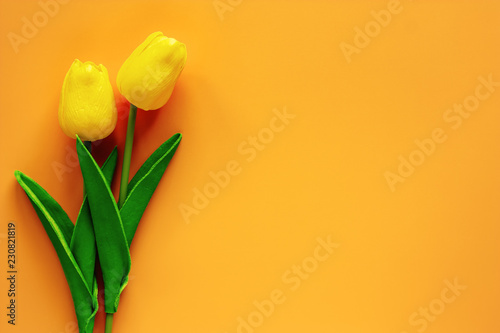 Artificial tulips on yellow...