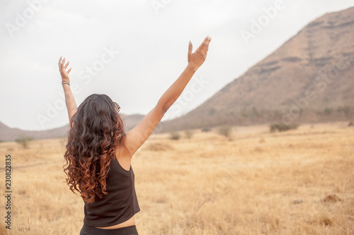 Asian girls spread their hands in the sky to show their happiness and victory with the concept of life and success on the sky in the morning. The silhouette of the girl raised her hand to thank God.