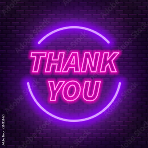Neon lettering thank you on a dark background.