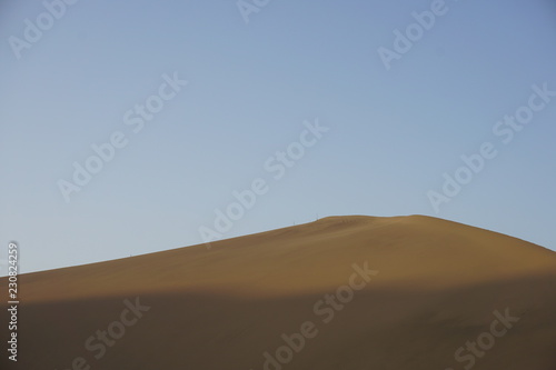 Desert sand dunes with blue sky, natural, beauty.
