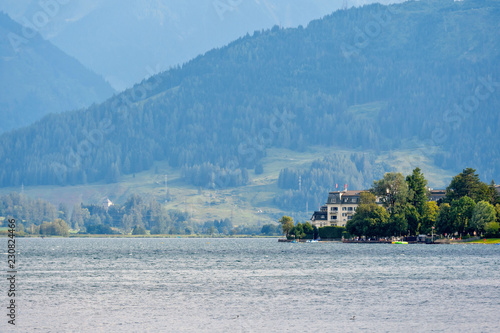 People relax at the Austrian mountain lake Worthersee.