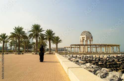 Woman Walking On Sunny Cliff In Kuwait City. View From Kuwait