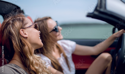 young women in a convertible car. © ASDF