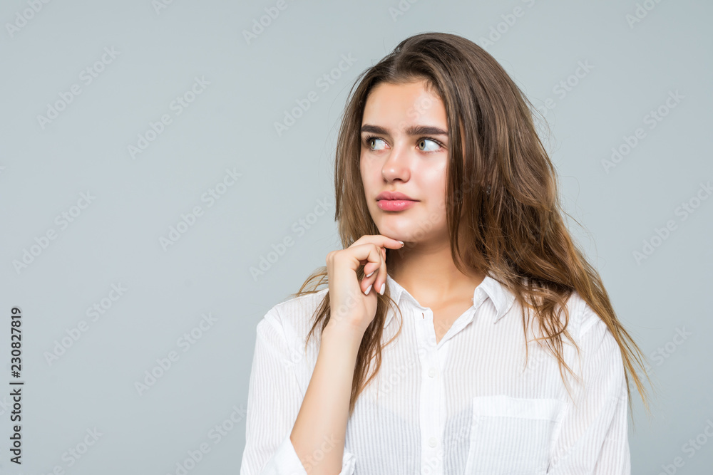 Young beautiful business woman hands on chin, thinking making choice, isolated on white background Young beautiful business woman hands on chin, thinking making choice, isolated on white background