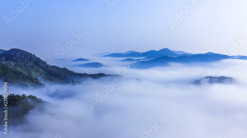 Beautiful view above the clouds on the mountains from the aerial view