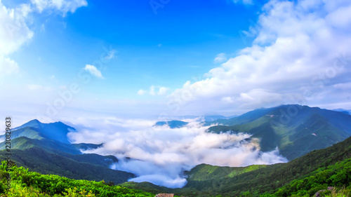 Beautiful view above the clouds on the mountains from the aerial view © FotoArtist
