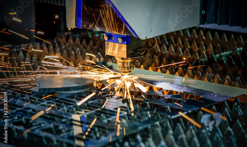 Milling machine working on steel detail with lot of sparks, Laser cutting with sparks close up, Laser close-up, Laser cutting tool.