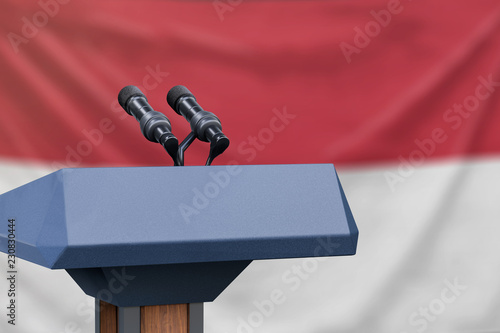 Podium lectern with two microphones and Indonesia flag in background