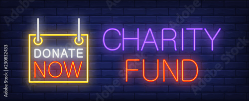 Charity fund neon sign. Glowing inscription with donate now sign on dark blue brick background. Can be used for charity organizations, support websites, online banners 