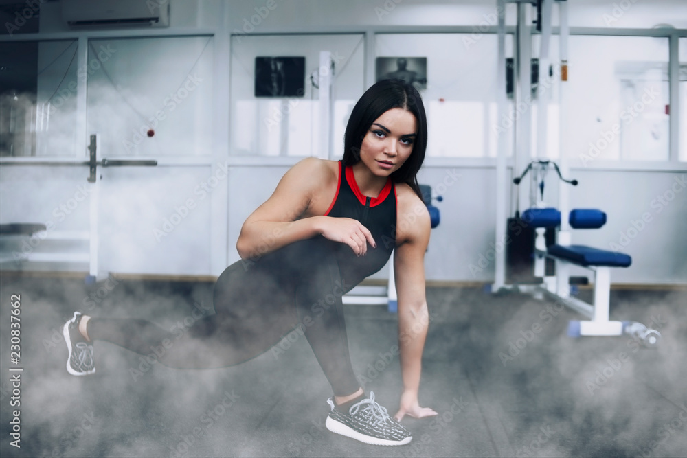 Fototapeta premium Beautiful girl in the gym, sportswear, athletic build.