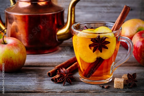 Hot mulled apple cider drink with cinnamon stick, cloves and anise