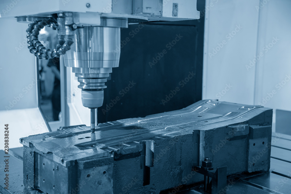 The CNC milling machine cutting the injection mold part by solid ball end mill tool.Mold manufacturing process. The CNC milling machine cutting the injection mold part by solid ball end mill tool.Mold manufacturing process.