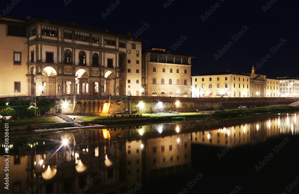 night scenery of Florence or Firenze city Tuscany Italy - Arno river with night lights reflections