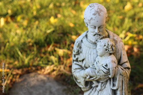 Religious statue on gravestone in cemetery  © Alex