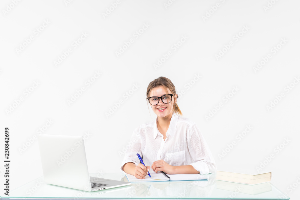 Portrait of an adorable business woman working at her desk with a laptop and paperwork isolated on white background Portrait of an adorable business woman working at her desk with a laptop and paperwork isolated on white background