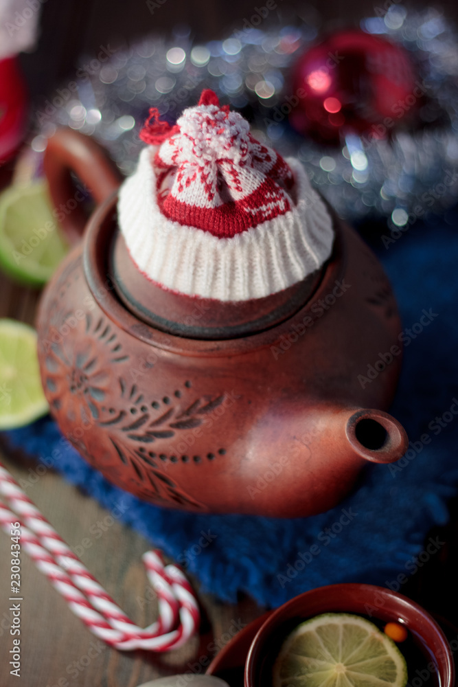 Christmas teapot with the red santa hat on it.