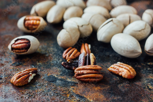 Pecan nuts on black rustic ...