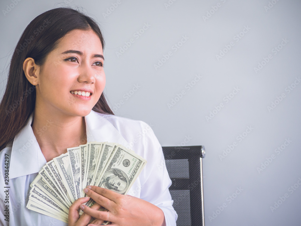 Business woman showing bill of dollars with smiling to successful for work. Business woman showing bill of dollars with smiling to successful for work.