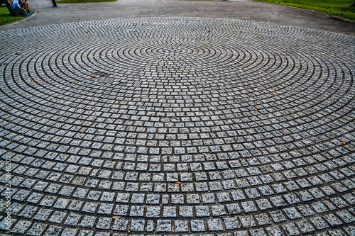circular design cobblestone park ground surface with trees all around