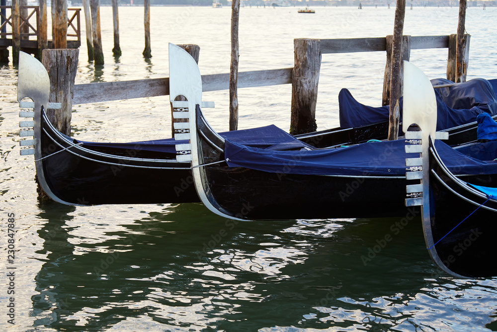 Three gondola boats moored in Grand Canal in Venice, Italy