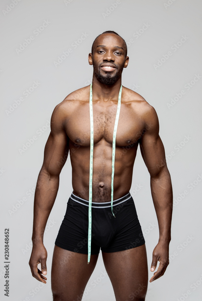 Black man, fitness and body, measuring tape and abs with health, weight  loss and active lifestyle o Stock Photo by YuriArcursPeopleimages