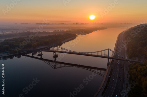 Sunrise aerial view of pedestrian Park bridgу, left bank of Kyiv and Dnipro river in Kyiv, Ukraine