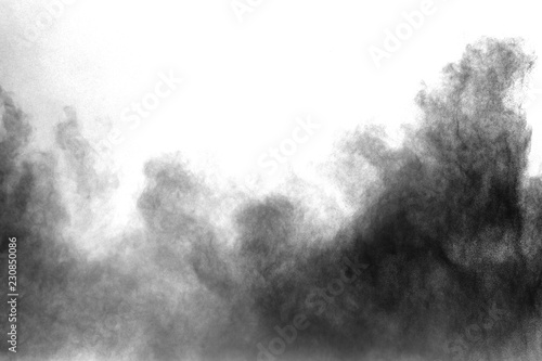 Black powder explosion on white background. Black dust particles splash.